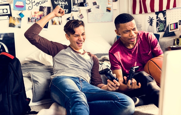 Two teen boys playing video games.