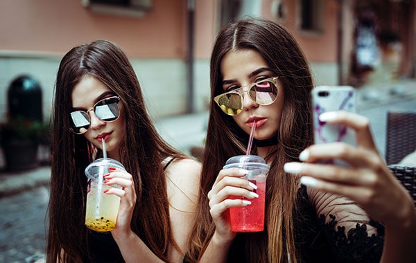 Teenage girls on phone selfie