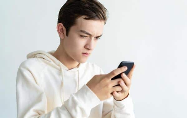 Male teen looking at his phone.