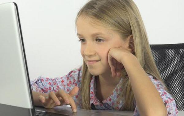 Young teen girl looking at a screen.