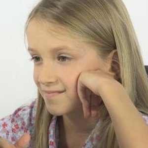 Young teen girl looking at a screen.