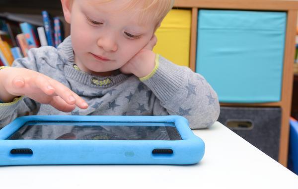 Child looking at a tablet.