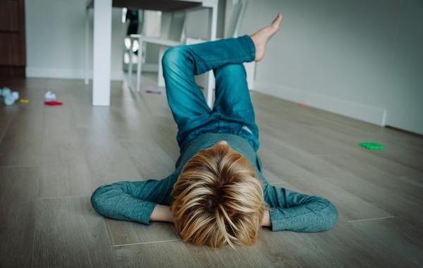Child lying on the floor relaxing.