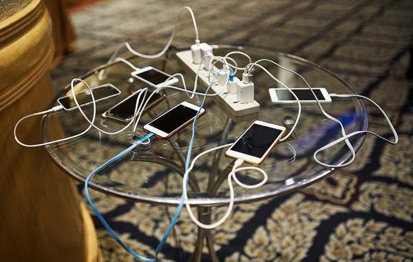 Glass table with multiple phones charging.