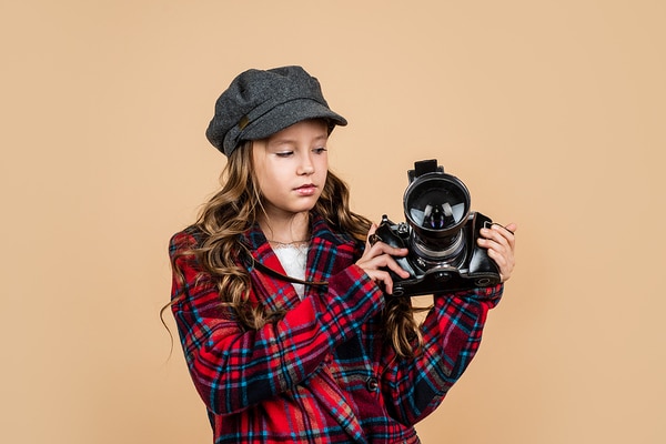 Teen holding a camera.