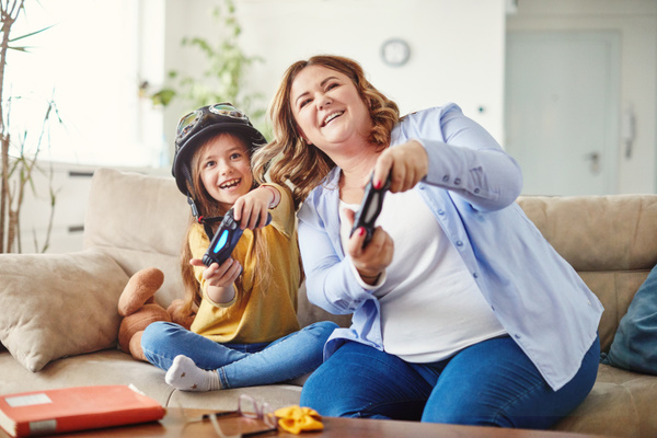 Adult and child playing video games.