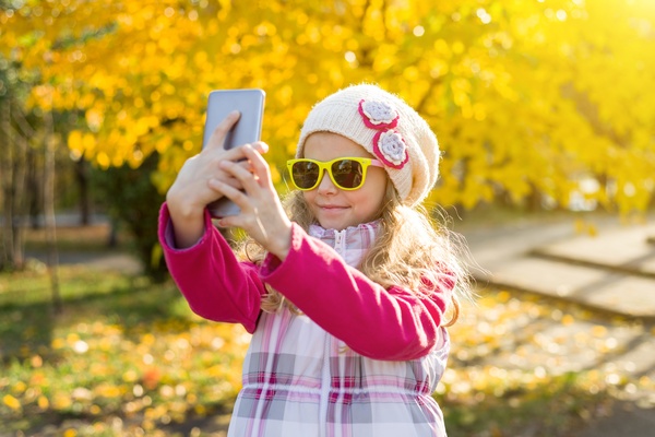 Child taking a selfie for Instagram.